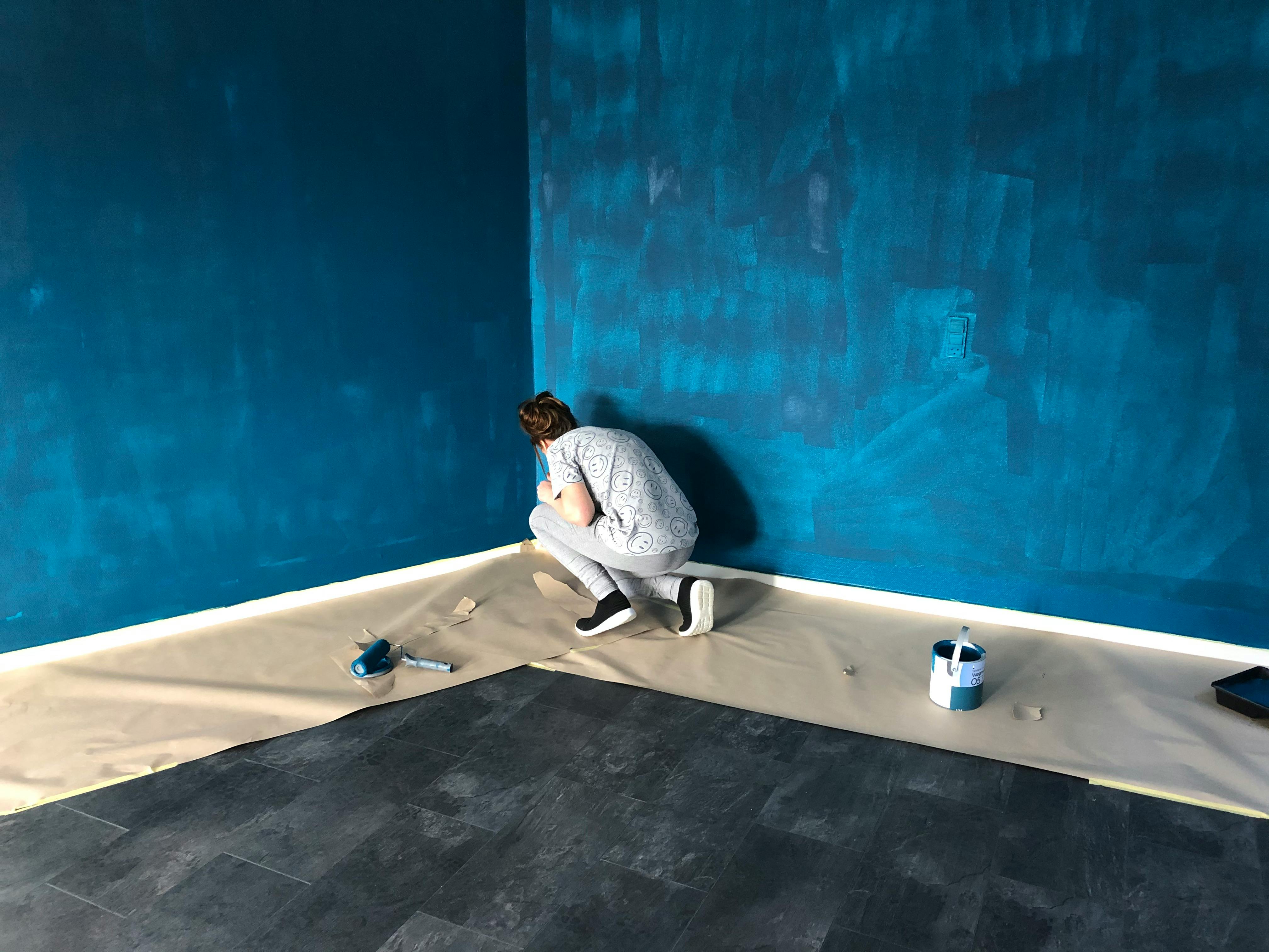 Woman Painting a Wall
